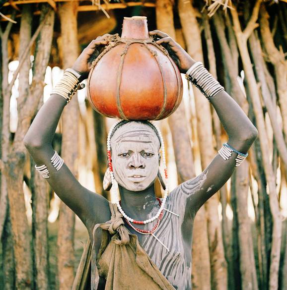 A Mursi woman from the Omo Valley carrying water / The Telegraph  Picture: Philip Lee Harvey 