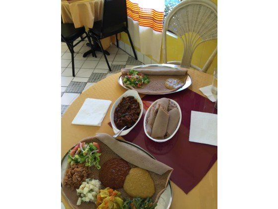 Veggie platter, lower corner; beef and injera bread, center; and veggie platter, far corner, which will be topped with the beef strips. CONTRIBUTING PHOTOGRAPHER , SHEILA BOYT